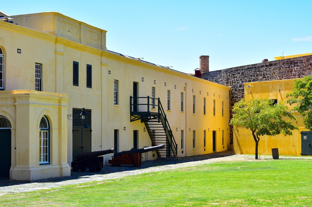 17th century yellow building with grassy courtyard